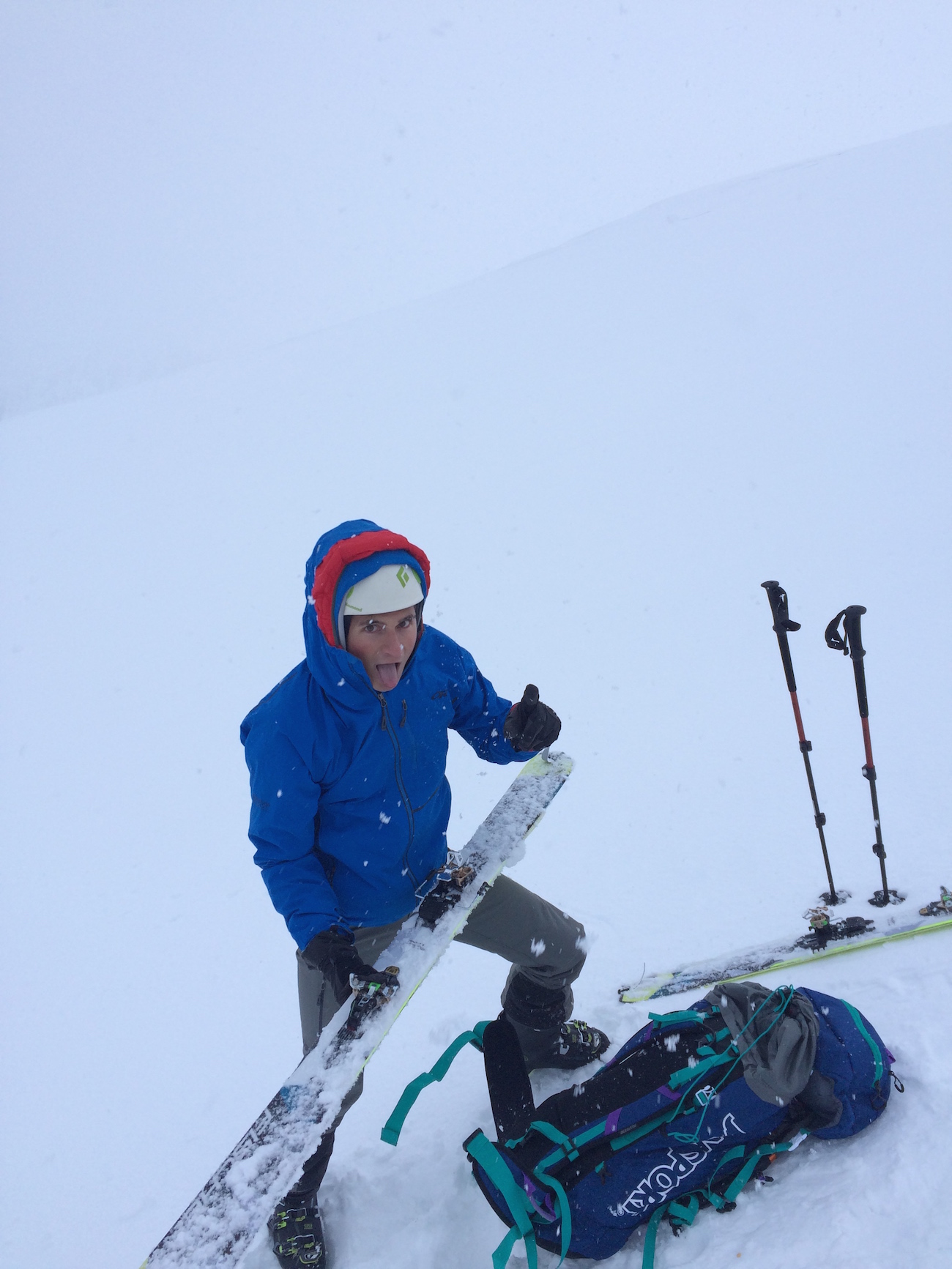 putting on skis in storm